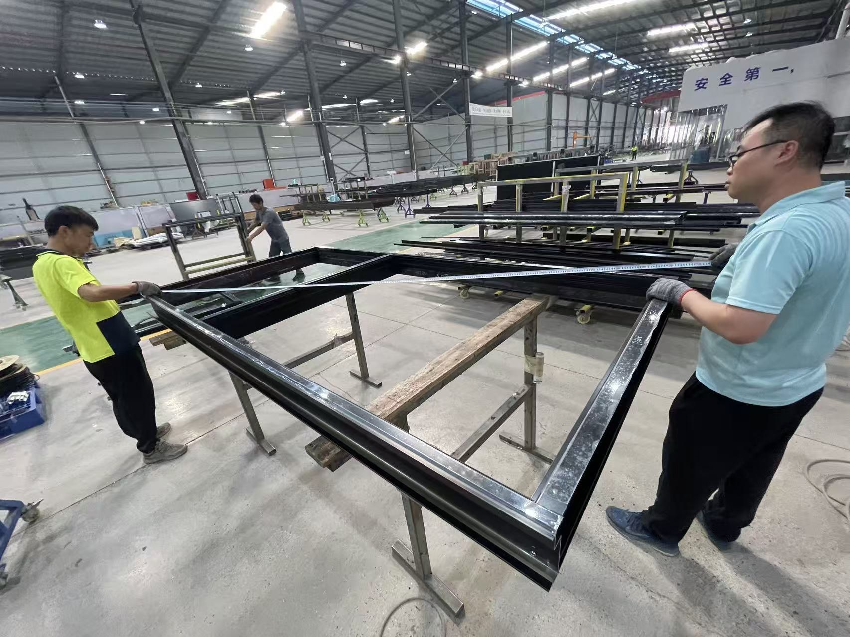 Factory team inspecting an assembled façade unit