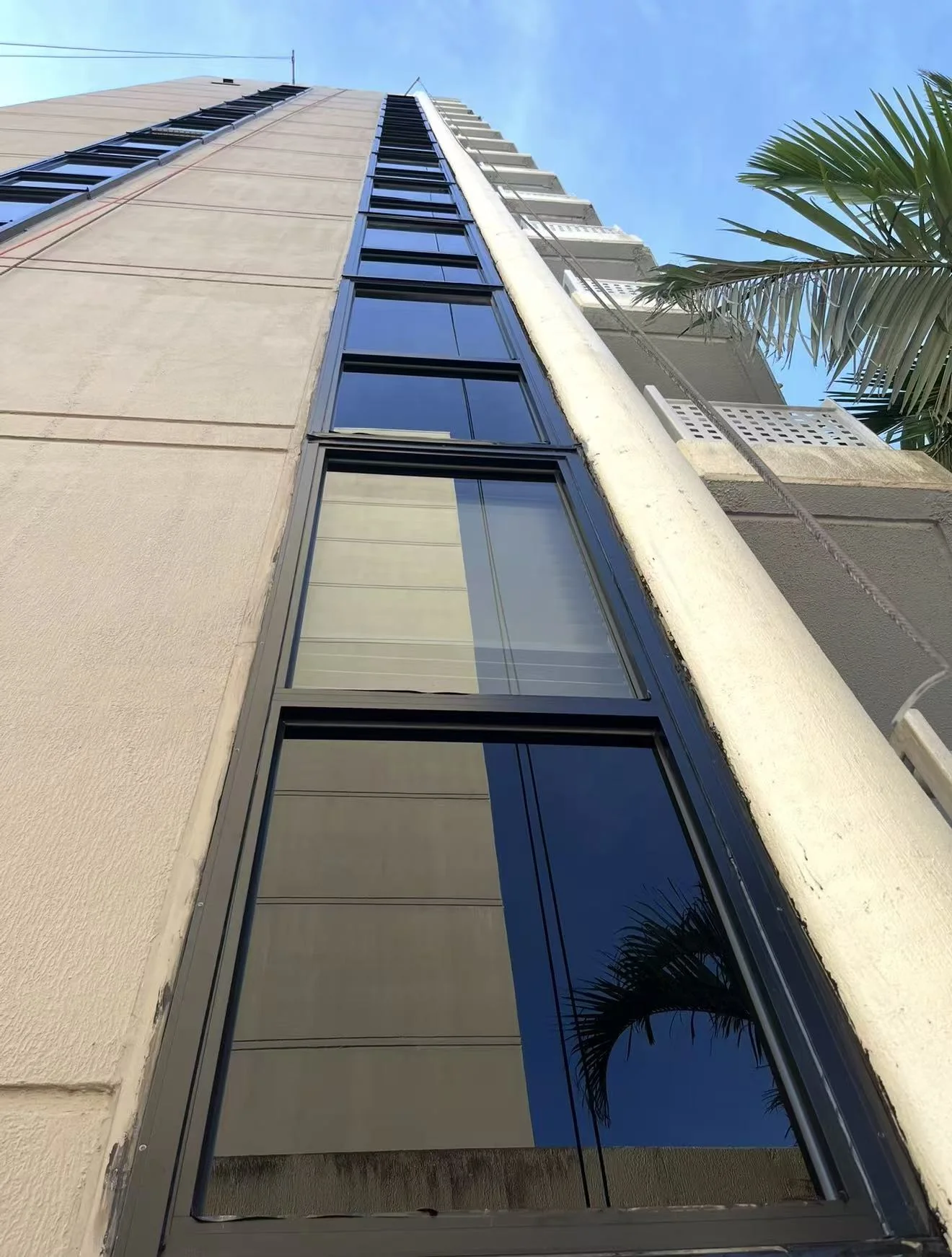 Vertical strip curtain wall viewed from below at Rydges Cairns